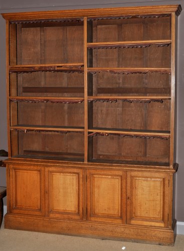 Lot 1121 - *A Victorian oak open bookcase, the flared...