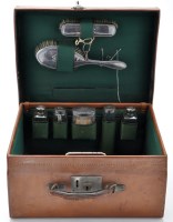 Lot 657 - A George V leather travel dressing table box,...