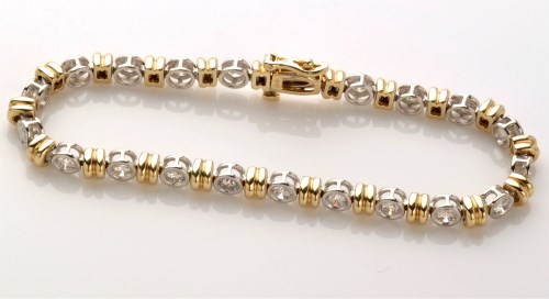 Lot 711 - A diamond line bracelet, the links alternately...