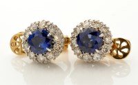 Lot 713 - A pair of sapphire and diamond cluster ear...
