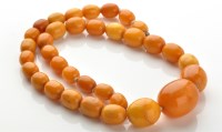 Lot 737 - A honeycomb amber necklace, the graduated to...