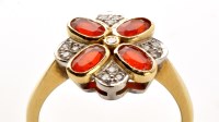 Lot 743 - An orange stone and diamond dress ring, the...
