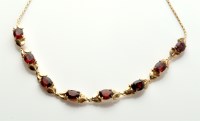 Lot 744 - A garnet and yellow metal necklace, each of...