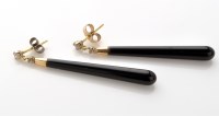 Lot 756 - A pair of onyx and diamond drop earrings, the...