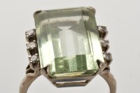 Lot 760 - A light green coloured gemstone and diamond...