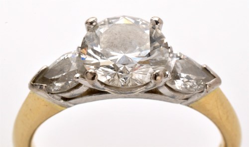Lot 764 - A three stone diamond ring, the central...