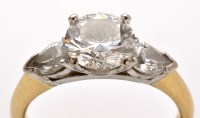 Lot 764 - A three stone diamond ring, the central...