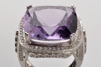 Lot 777 - An amethyst and diamond ring, the central...