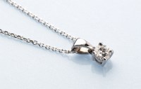 Lot 786 - A solitaire diamond drop pendant, weighing...
