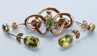 Lot 793 - A pair of peridot drop earrings, each with an...