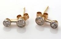 Lot 803 - A pair of diamond stud earrings, each with two...