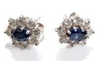 Lot 819 - A pair of sapphire and diamond cluster...