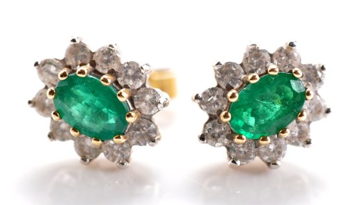 Lot 820 - A pair of emerald and diamond cluster earrings,...