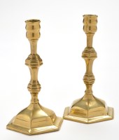 Lot 861 - A pair of 18th Century brass candlesticks, the...