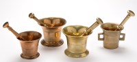 Lot 863 - Two bronze and two brass pestle and mortars,...