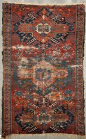 Lot 1118 - A Caucasian rug, with geometric medallions on...