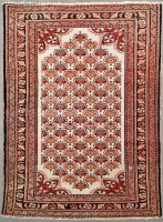 Lot 1125 - A Nahavand rug, with floral motifs to ivory...