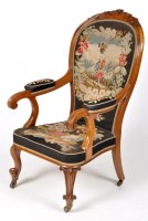 Lot 1175 - A Victorian carved walnut open arm easy chair,...