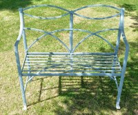 Lot 1284 - A cast iron two-seat garden bench, with reeded...