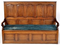 Lot 1294 - A 19th Century oak settle, the high panelled...