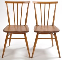 Lot 144 - Ercol: two elm seated spindle back chairs,...