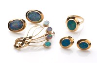 Lot 910 - An opal and yellow metal scrolling brooch,...