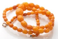 Lot 923 - An amber bead necklace, the graduated beads...