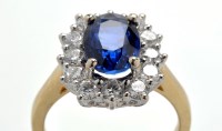 Lot 924 - A sapphire and diamond cluster ring, the oval...