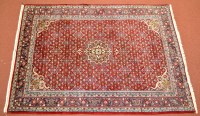 Lot 990 - A Persian Bijar carpet, the red field with...