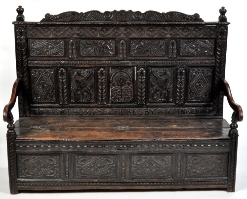 Lot 1073 - A 17th Century carved oak settle, the back...