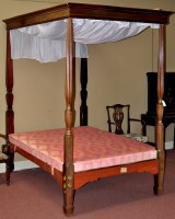 Lot 1077 - A mahogany four poster bed, the flared canopy...