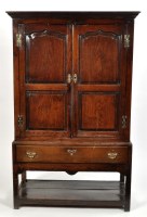 Lot 1125 - A mid 18th Century oak cupboard, the flared...