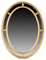 Lot 1132 - A carved giltwood and gesso oval wall mirror,...