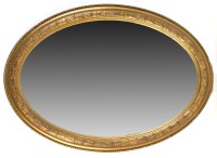 Lot 1138 - A 19th Century oval wall mirror, the bevelled...