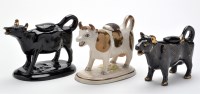 Lot 73 - Three cow creamers, of possible North East...