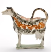 Lot 114 - Creamware cow creamer, with tail looped over...