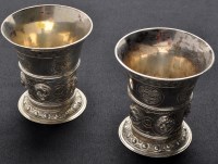 Lot 725 - A pair of Continental white metal beakers,...