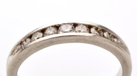 Lot 762 - A diamond half hoop eternity ring, the nine...