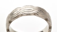 Lot 763 - A platinum eternity ring, of textured Celtic...