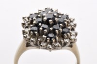 Lot 765 - A sapphire and diamond cluster dress ring, the...