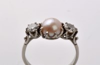 Lot 769 - A pearl and diamond ring, the central pearl...