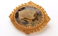 Lot 770 - A 9ct. yellow gold and citrine brooch, the...