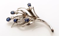 Lot 776 - A sapphire, diamond and 9ct. white gold floral...