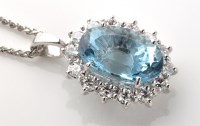 Lot 786 - An aquamarine and diamond cluster pendant, the...