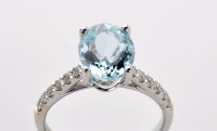 Lot 787 - An aquamarine and diamond ring, the oval facet...