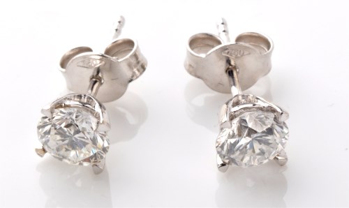 Lot 789 - A pair of diamond stud earrings, each...
