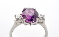 Lot 793 - A fancy pink sapphire and diamond ring, the...