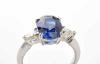 Lot 794 - A sapphire and diamond ring, the oval facet...