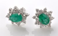 Lot 795 - A pair of emerald and diamond cluster earrings,...