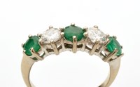 Lot 813 - An emerald and diamond ring, the three...